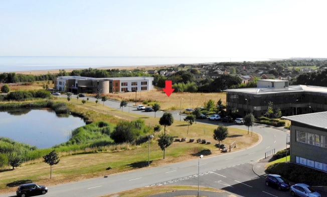 Aerial view of North Wales Business Park, Abergele, with the proposed site marked by a red arrow